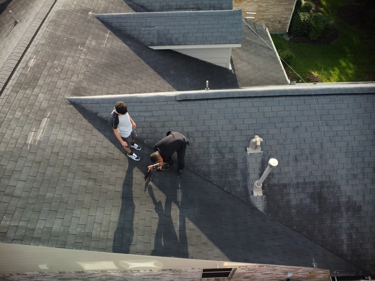 E Torres Solutions inspecting roof conditions on a residential property