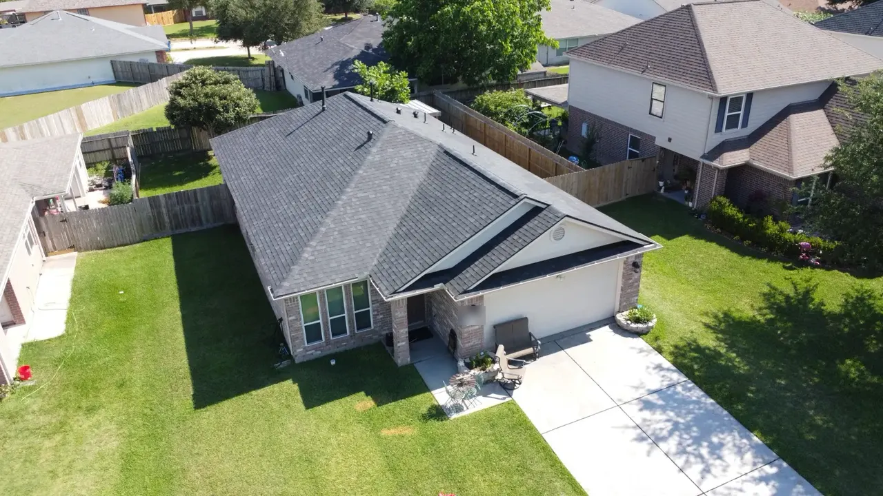 Dark shingle roof on a single-story brick home, installed by E Torres Solutions