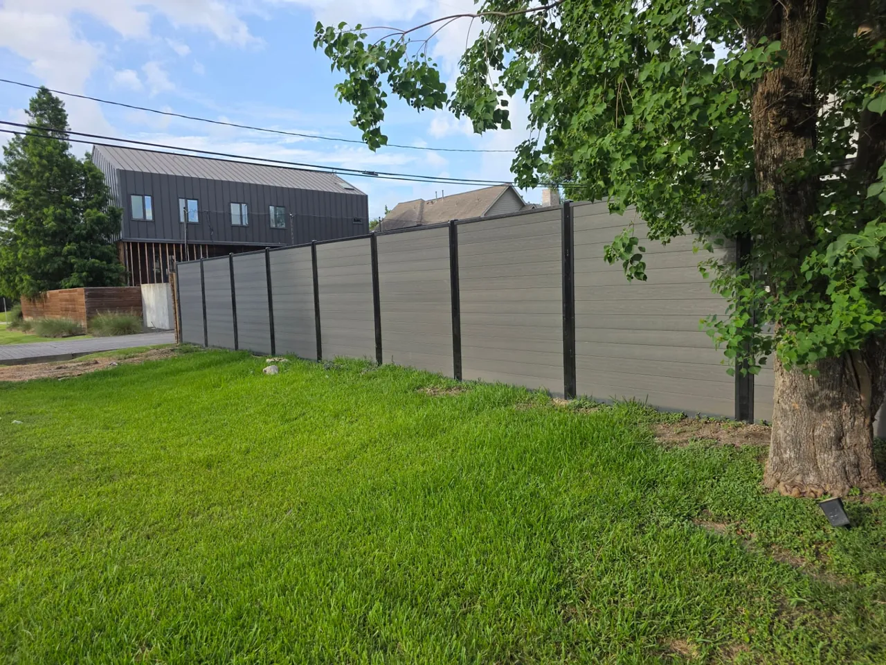 Completed privacy fence with Composite Picket panels and fence support posts.