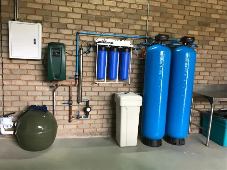 Example of whole-home water-treatment equipment installed against a brick wall