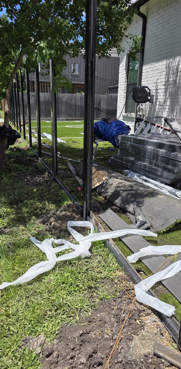 Fence line and post preparation documented during an E Torres Solutions project.